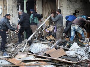 Syrian men search for survivors following an air strike on the village of Maaret al-Numan, in the country's northern province of Idlib, on December 4, 2016. (AFP/Mohamed al-Bakour)