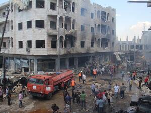 A picture taken on June 12, 2016 shows Syrian Civil Defense members, known as the White Helmets, gather at a site following air strikes on the rebel-held northwestern city of Idlib, on June 12, 2016. (AFP/Omar Haj Kadour)