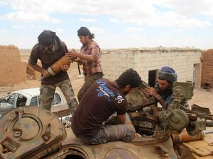 Rebel fighters from the Jaish al-Fatah (or Army of Conquest) brigades load ammunitions into a tank during clashes with Syrian pro-government forces near the village of Om al-Krameel, in Aleppo's southern countryside on May 5, 2016. (AFP/Omar Haj Kadour)