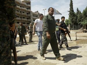 This file photo taken on April 30, 2016 shows Jowan Ibrahim (C), the commander of the Kurdish police (aka Asayish) arriving at a checkpoint where a suicide bomber killed five Kurdish policemen in Syria's divided northeastern city of Qamishli. (AFP/Delil Souleiman)