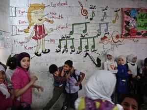 Syrian children play in one of the underground rooms of the Al-Hayat school in Damascus' north eastern rebel-held al-Qaboun surburb, which is under a truce with the regime, on October 19, 2016. (AFP/Sameer al-Doumy)