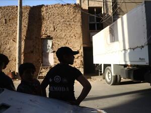 Syrian boys stand next to an Arab Red Crescent lorry carrying humanitarian aid in the rebel-held town of Douma, east of the Syrian capital Damascus, on October 19, 2016. (AFP/Abd Doumany)