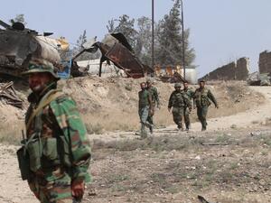 Syrian pro-regime fighters patrol the Ramussa area south of the city of Aleppo, on September 21, 2016. (AFP/George Ourfalian)