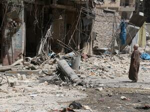 A resident of the Tariq al-Bab neighborhood of Aleppo, inspects the damage caused by reported air raids that targeted rebel-held areas in the northern city on August 16, 2016. (AFP/Thaer Mohammed)
