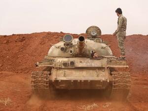Syrian rebel-fighters from the National Liberation Front (NLF) secure a tank, part of heavy weapons and equipment withdrawn yesterday from a planned buffer zone around Idlib. (OMAR HAJ KADOUR / AFP)