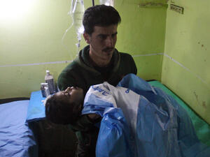 An unconscious Syrian child is carried at a hospital in Khan Sheikhun, a rebel-held town in the northwestern Syrian Idlib province, following a suspected toxic gas attack on April 4, 2017. (AFP/Omar Haj Kadour)