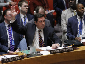 Russian Deputy Permanent Representative to the United Nations Vladimir Safronkov holds up his hand as he votes against a Draft resolution that condemns the reported use of chemical weapons in Syria at the Security Council on April 12, 2017 at UN Headquarters in New York. (AFP/Kena Betancur)