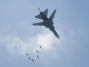 A Syrian government forces' MiG-23 fighter-bomber drops a payload during a reported air strike in the rebel-held area of Qabun, east of the capital Damascus, on May 6, 2017. (AFP/Amer Almohibany)