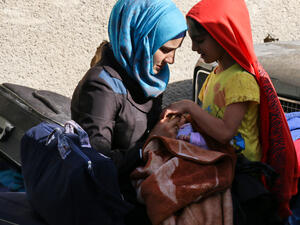 A Syrian woman and girl wait to be evacuated from opposition-held Barzeh, May 8 2017. (AFP/Sari Abu Zaid)