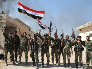 Syrian army units and pro-government forces deploying at an undisclosed location in the Atshan village in Hama. (AFP/File)