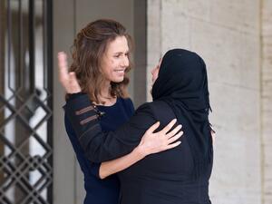 Asma al-Assad greets a Syrian mother, 21 March 2017. (Syrian Presidency)