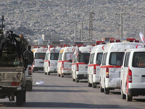 A convoy of ambulances transporting wounded civilians and rebels from the villages of Fuaa and Kafraya, the last two regime-held villages in Idlib province, is guarded as it heads towards the Cilvegozu crossing with Turkey on December 28, 2015 (AFP Photo/Omar Haj Kadour)