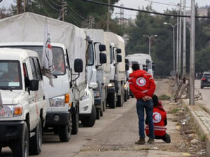 A convoy of aid from the International Committee of the Red Cross (ICRC) waits on the outskirts of the besieged rebel-held Syrian town of Madaya, on January 11, 2016. (AFP/Louai Beshara)