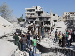 Syrian residents and members of the Syrian Civil Defence, also known as White Helmets, search for victims amid the rubble of a building following a reported overnight air strike in the rebel-held town of Armanaz, in Idlib province near the Turkish border, on September 30, 2017 (Omar Haj Kadour/AFP)