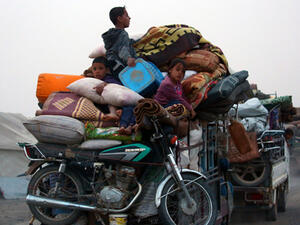 Displaced Syrians, who fled the countryside surrounding the Islamic State (IS) group stronghold of Raqqa, arriving at a temporary camp in the village of Ain Issa (AFP)