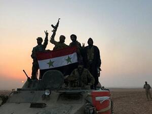 Syrian forces celebrate victory in a village near al-Boukamal. (AFP/ File)
