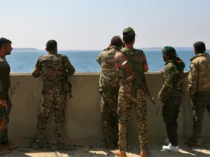 Members of the US-backed Syrian Democratic Forces stand on the Tabqa dam recaptured during their drive on the Islamic State group's stronghold in nearby Raqa. (AFP)