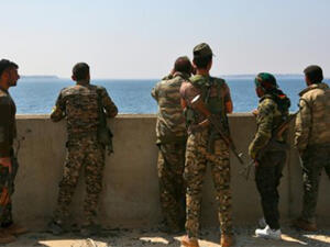 Members of the US-backed Syrian Democratic Forces stand on the Tabqa dam recaptured during their drive on the Islamic State group's stronghold in nearby Raqa. (AFP)