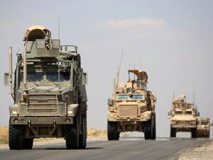 US-made armoured vehicles are seen on a road near the northern Syrian village of Ain Issa on June 3, 2017. (Delil Souleiman/AFP)