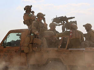 US special operations personnel ride in a pickup truck in the village of Fatisah in the northern Syrian province of Raqa on May 25, 2016 (AFP Photo/Delil Souleiman)