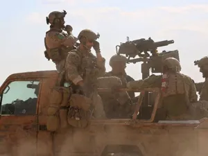 Armed men in uniform identified by Syrian Democratic Forces as US special operations personnel ride in a pickup truck in the village of Fatisah in the northern Syrian province of Raqa on May 25, 2016 (AFP/Delil Souleiman)