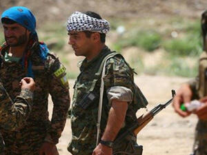Members of the YPG and Syrian Democratic Forces in a distrcit of Raqqa on June 11. (AFP/Delil Souleiman)