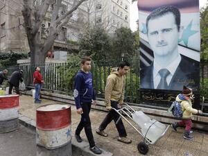 Syrians fill plastic containers with water at a public fountain in the capital Damascus on January 3, 2017. (AFP/Louai Beshara)