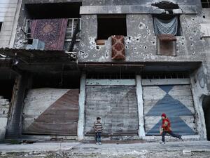 Syrian children play next to a destroyed buidling in the rebel-held town of Douma, on the eastern outskirts of the capital Damascus, on January 9, 2017. (AFP/Abd Doumany)