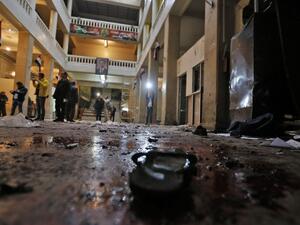 Syrian security forces and journalists stand inside the old palace of justice building in Damascus following a reported suicide bombing on March 15, 2017. (AFP/Louai Beshara)