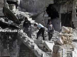 A Syrian family cleans the rubble from their destroyed house in Karm al-Jabal neighbourhood in the Northern Syrian city of Aleppo on March 9, 2017. (AFP/Joseph Eid)