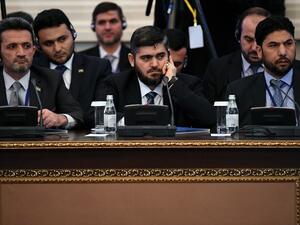 This file photo taken on January 23, 2017 shows chief opposition negotiator Mohammad Alloush (C) of the Jaish al-Islam (Army of Islam) rebel group attending the first session of Syria peace talks at Astana's Rixos President Hotel. (AFP/Kirill Kudryavtsev)