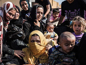 Syrian refugees from Raqqa governorate cross the Syria-Turkey border fleeing Isis in this file photo dated June 22 2015. (AFP)