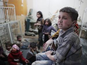Syrian children wait to receive treatment at a makeshift clinic following reported air strikes by government forces in the rebel-held town of Douma, on the eastern outskirts of Damascus, on April 4, 2017. (AFP/Abd Doumany)