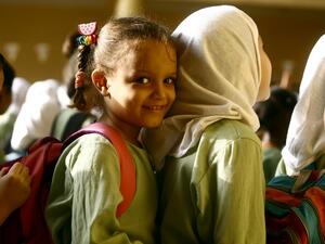 Syrian girls, who fled the ongoing conflict in Syria, stand in line at an all girls school in the south of Khartoum on September 19, 2017. (AFP/Ashraf Shazly)