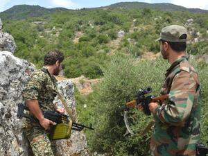 Syrian pro-regime forces patrol in the Hama province, as families move back into the area. (AFP/File)