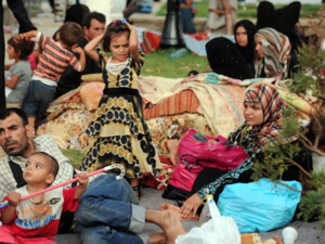 Syrian refugees wait in Port Said Square in Algiers, Algeria. (AFP/File)