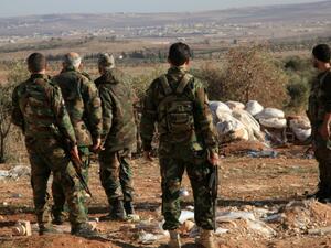 Syrian regime security forces overlook the Hama province. (AFP/File)