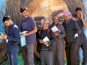 Syrian refugees queue to register their names for employment at the Zaatari refugee camp, on October 4. (AFP)