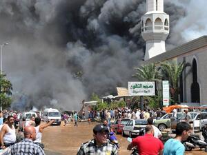 People run from the site of a bombing at a Tripoli mosque in 2013. (AFP/File)