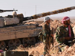 Regime-loyal militia soldiers overlooking a town near Deir Ezzour, AFP