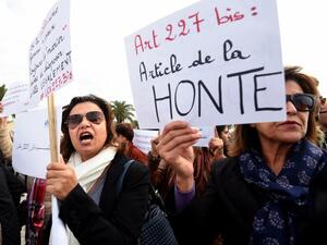 Tunisian women protest an article of the country's penal code that allowed rapists to marry their victims (AFP)
