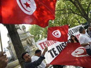 Protesters wave Tunisian flags during a demonstration against terrorism in Paris on June 27, 2015, a day after a deadly attack on a Tunisian beach resort. (Loic Venance/ AFP) Protesters wave Tunisian flags during a demonstration against terrorism in Paris on June 27, 2015, a day after a deadly attack on a Tunisian beach resort. (Loic Venance/ AFP)