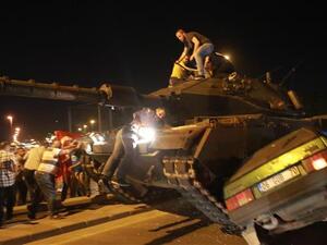 A tanks drives over a car during the failed coup attempt in Ankara. (AFP/File)