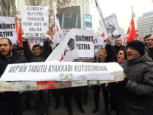People shout anti-government slogans as they carry a casket made of empty shoe boxes during a protest against corruption in Ankara, on December 21, 2013. [AFP]