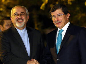 Turkish Foreign Minister Ahmet Davutoglu (R) shakes hands with his Iranian counterpart Javad Zarif prior to a meeting in Ankara. (Image credit: AFP) 