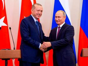 Russian President Vladimir Putin, right, and Turkish President Recep Tayyip Erdogan shake hands .(AFP/File)