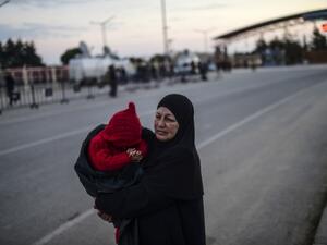 Syrian refugees wait for other family members to cross the border into Turkey. (AFP/File)