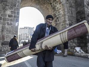 A man leaves his house during a curfew in the Sur district of Diyarbakir on February 3, 2016. (AFP/Ilyas Akengin)
