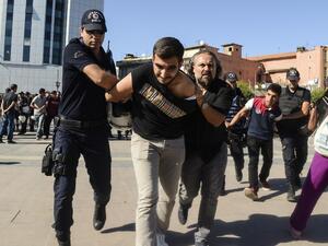 Turkish police detain a student in Diyarbakir on September 19, 2016, during a protest against the suspension of teachers for suspected links to militants. (AFP/Ilyas Akengin)