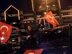 A man waves a Turkish national flag during a demonstration on December 11, 2016 a day after twin bombings near the home stadium of Besiktas football club. (AFP/Yasin Akgul)